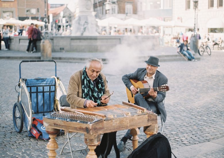 Photo of Two men performing in the street by brandon-hoogenboom on Unsplash